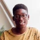 portrait-of-smiling-young-man-in-loft-apartment-2021-08-26-16-15-28-utc-1